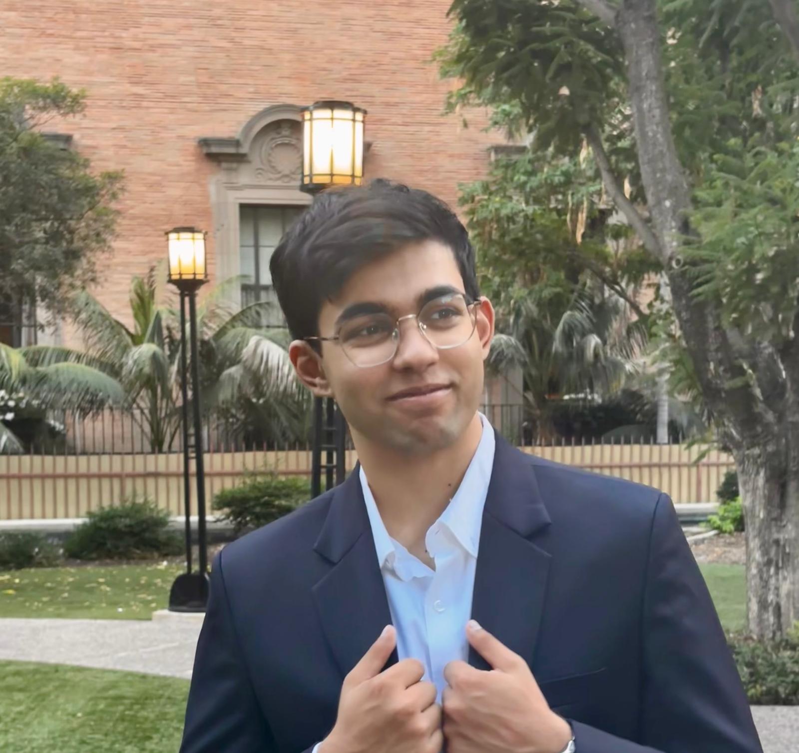 Shree Khangaonkar outdoors in a suit jacket